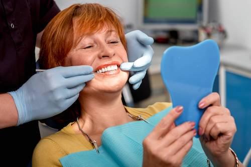 An elderly woman trying out Dentures in Pampa, TX